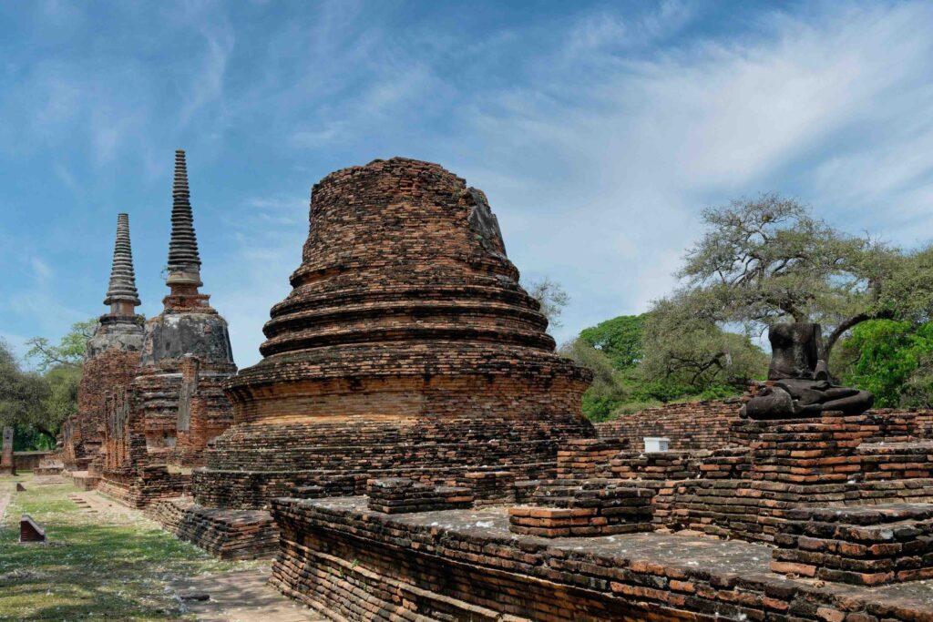 Budgeting for Thailand Travel: Why “Cheap” Trip Often Costs More Than You Expect Ancient brick chedi and spires of Ayutthaya under blue sky, budgeting for Thailand travel guide