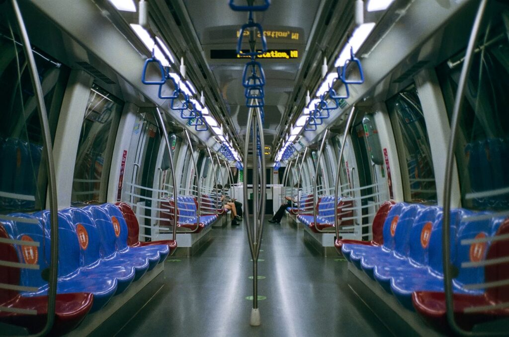 Interior of a Singapore MRT train with empty seats, an affordable and efficient way to get around the city