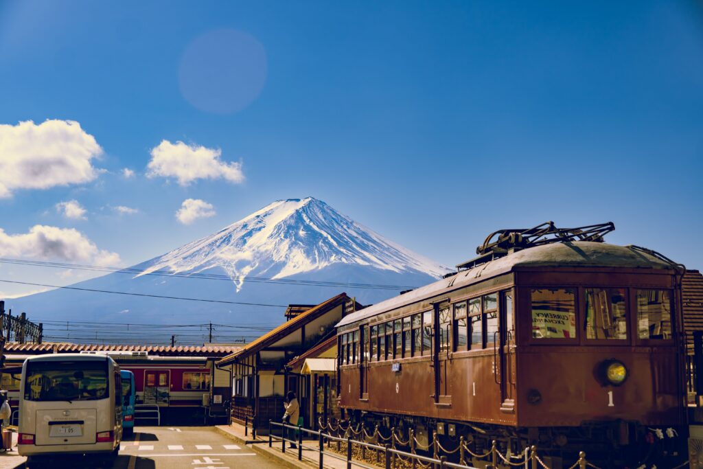 Getting Around Japan: How Transportation Shapes the Way Your Trip Unfolds A vintage train at a station with Mount Fuji behind, getting around Japan transportation guide