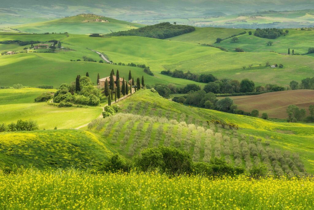 Best Time to Visit Italy: Seasonal Travel Tips for Ideal Weather and Festivals Rolling green Tuscany hills with cypress trees and a stone farmhouse in spring, Italy
