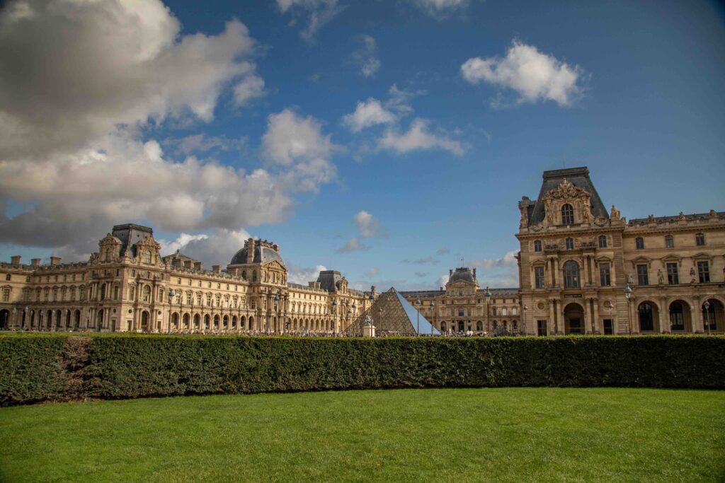 Best Time to Visit France: A Complete Seasonal Guide for First-Time Travelers The Louvre palace and glass pyramid under blue sky, Paris, France