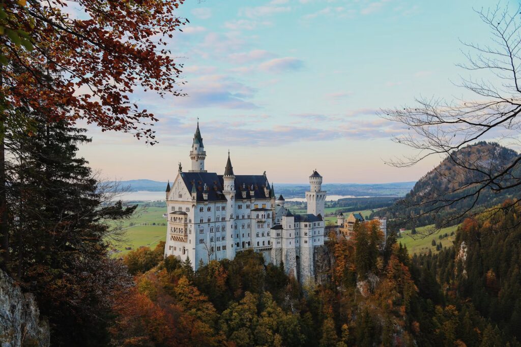 Best Time to Visit Germany: A Seasonal Guide to Weather, Festivals, and Top Destinations Neuschwanstein Castle among autumn forest with lake and valley behind, Bavaria, Germany