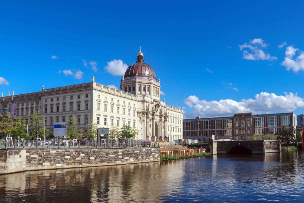 Discover Berlin’s Best Historical, Cultural, and Modern Spots for Your Next Adventure Berlin Palace Humboldt Forum with golden dome beside the River Spree under blue sky, Berlin