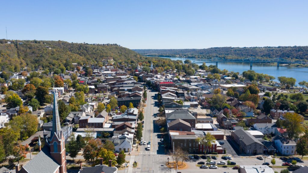 15 Best Places to Visit in September USA (2026): Perfect Early Fall Getaways An aerial view of a charming small town nestled among trees, one of the best places to visit in September USA.