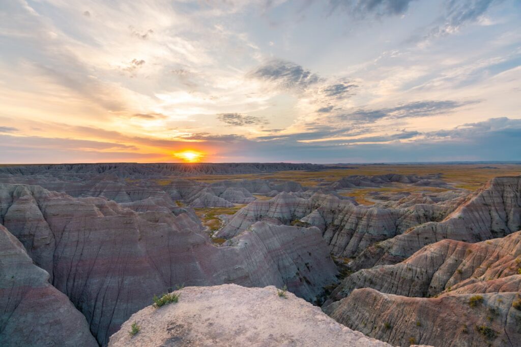 Vibrant sunset over Badlands rock formations, highlighting one of the best family vacation spots