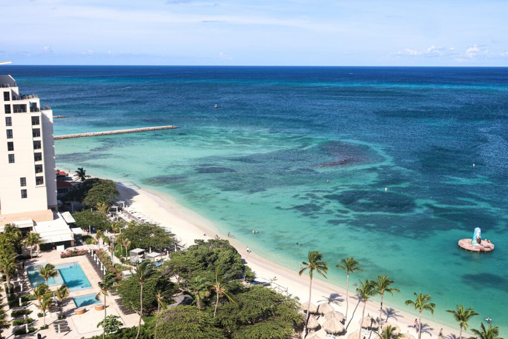 High-rise beachfront hotel overlooking pristine ocean waters, known as one of the best caribbean resorts for families