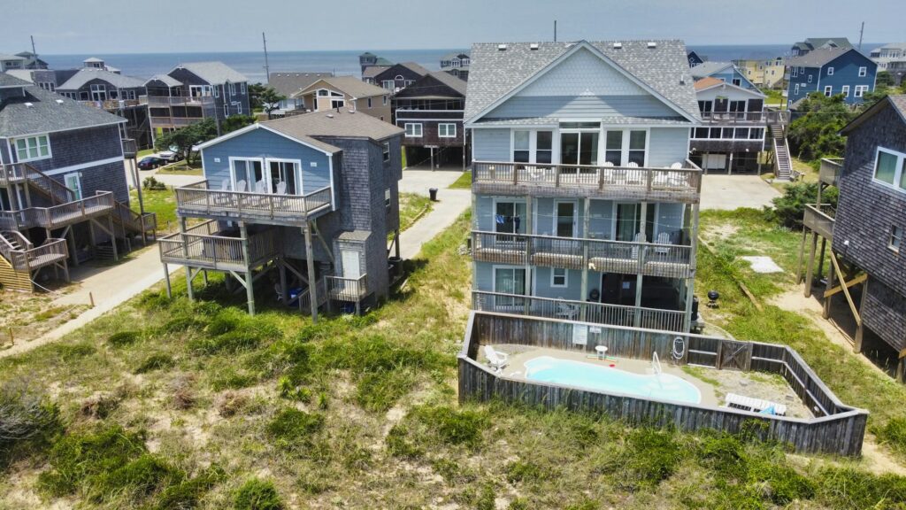 Beachfront homes and dunes in Outer Banks, NC, ideal for cheap family vacations