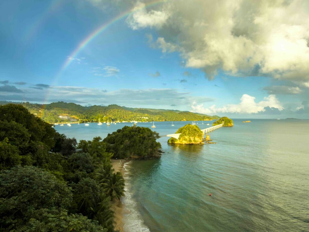9 Cheapest Caribbean Islands to Visit: Stop Overpaying in 2026 A serene beach with clear blue water, setting the scene for beautiful affordable caribbean islands