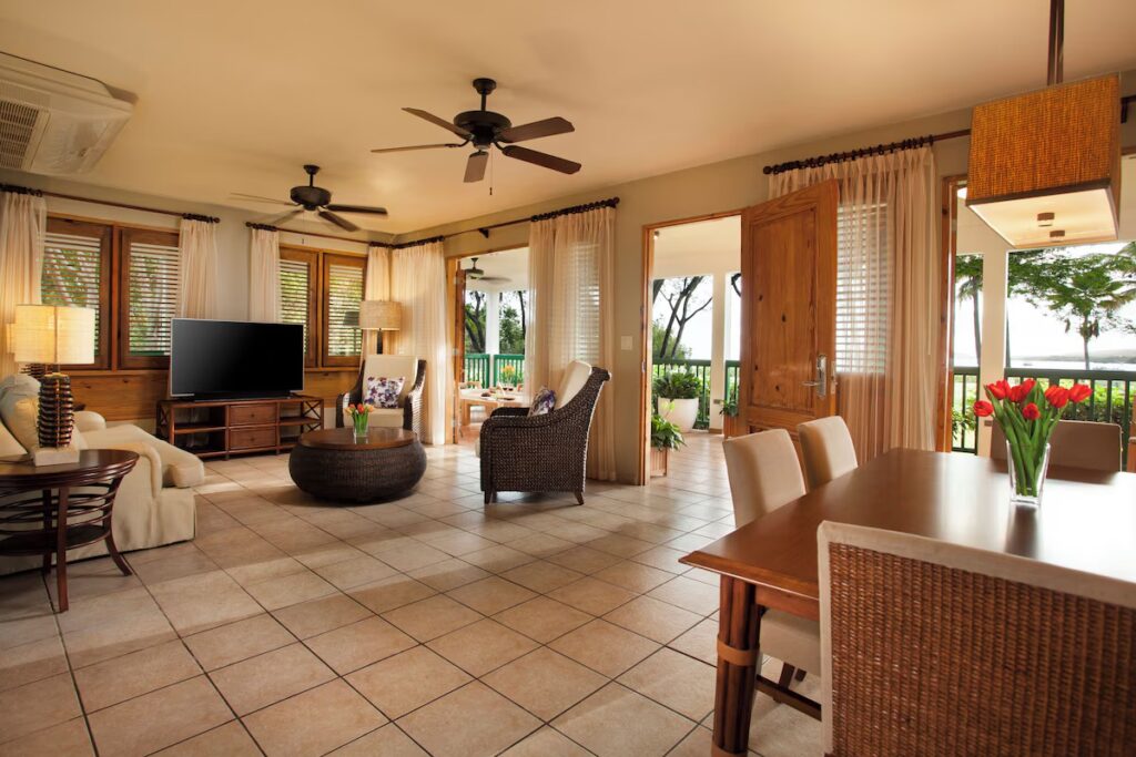 Spacious living room and dining area with a balcony in a Copamarina suite 