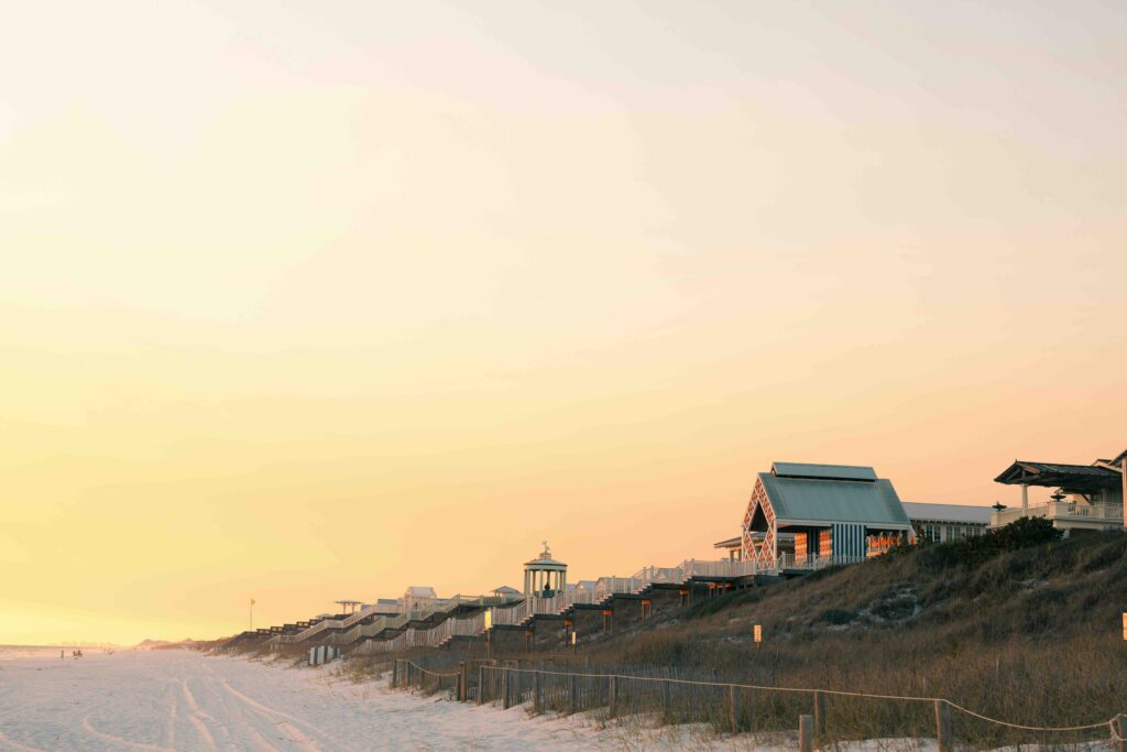 Soft sunset over white sand beaches and charming beachfront homes, ideal for relaxing fun vacations for kids