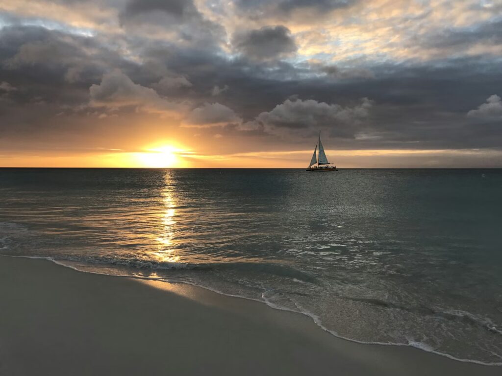 Sailboat at sunset on Eagle Beach, making Aruba one of the best caribbean islands to visit 