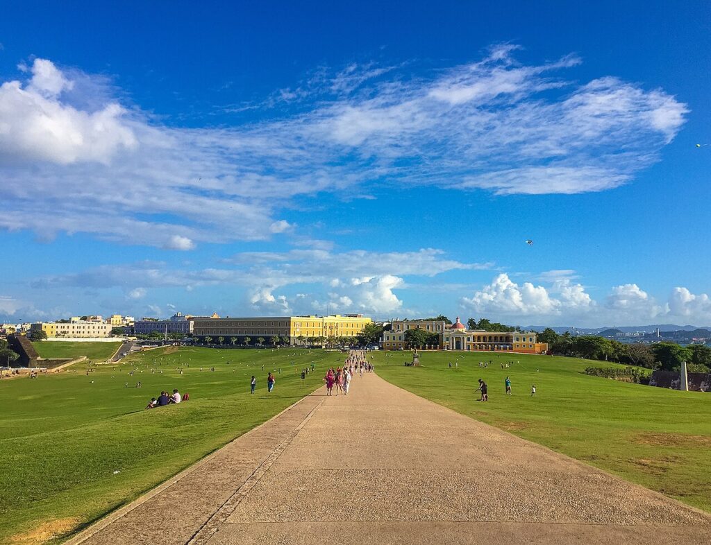 Walking path across the wide green lawn of El Morro in Puerto Rico, perfect for best caribbean islands for families