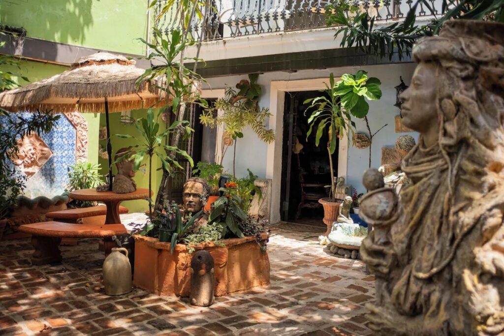 Courtyard with statues and potted plants at The Gallery Inn, among boutique hotels in old san juan. 