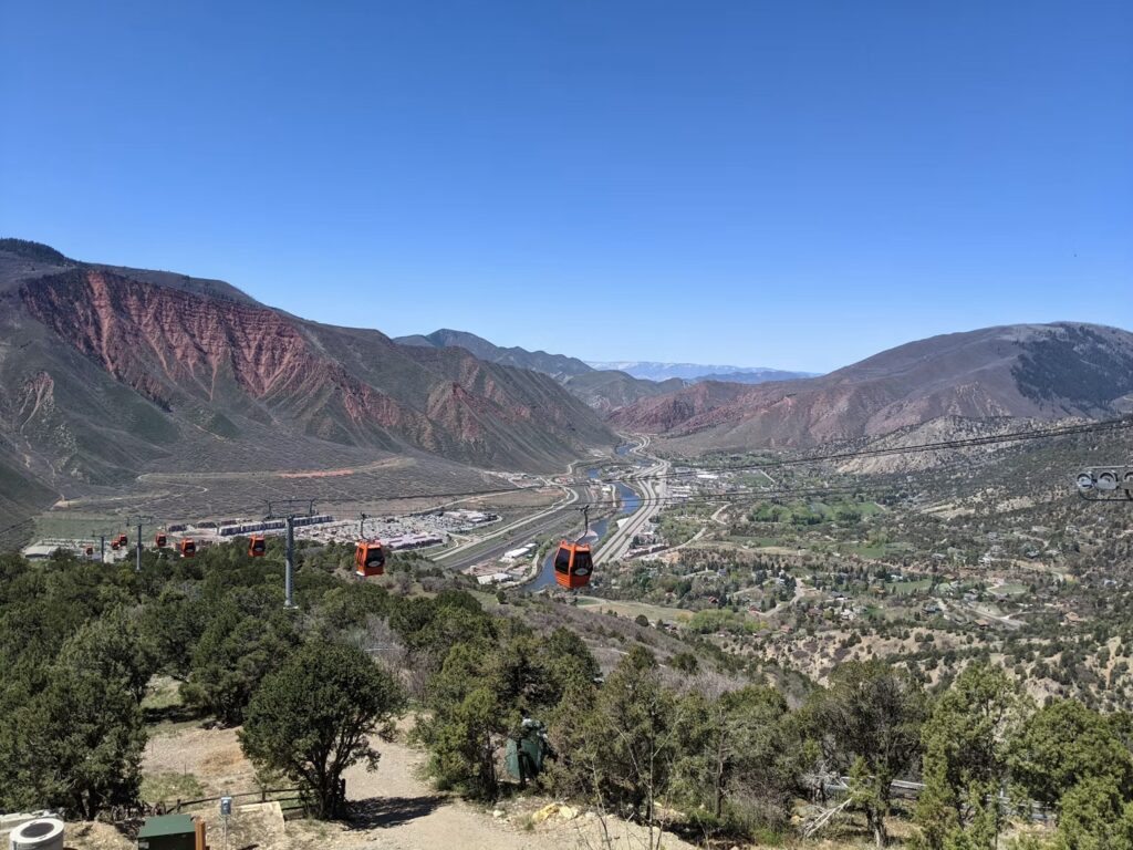 Red gondolas in Glenwood Springs, offering access to top Colorado vacation spots. 
