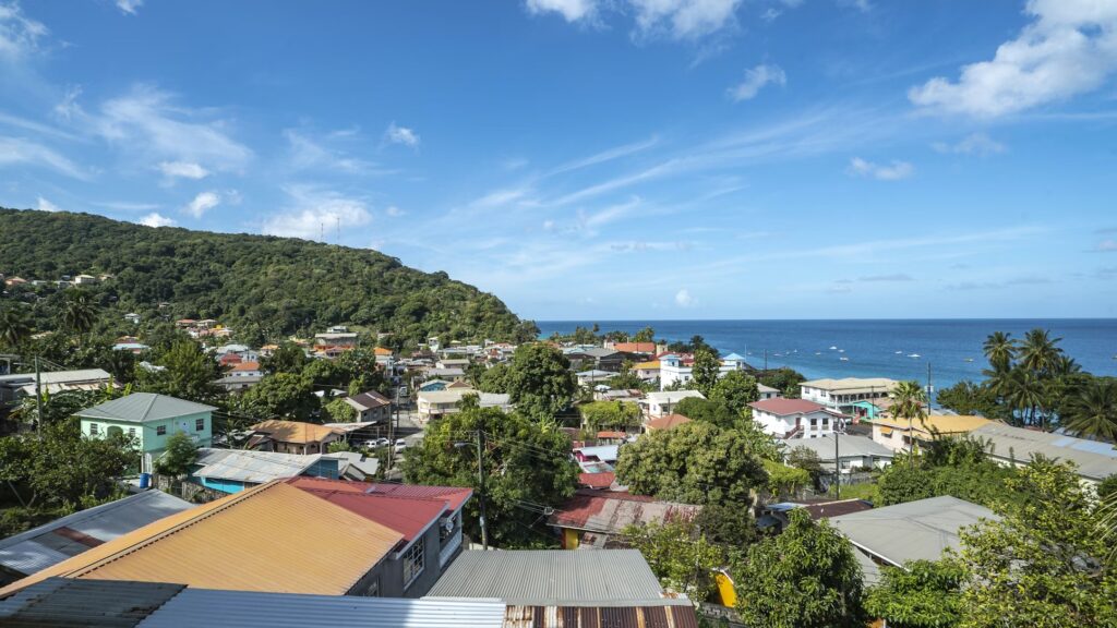 Lush green hills and colorful harbor in Grenada, a beautiful gem among affordable caribbean islands