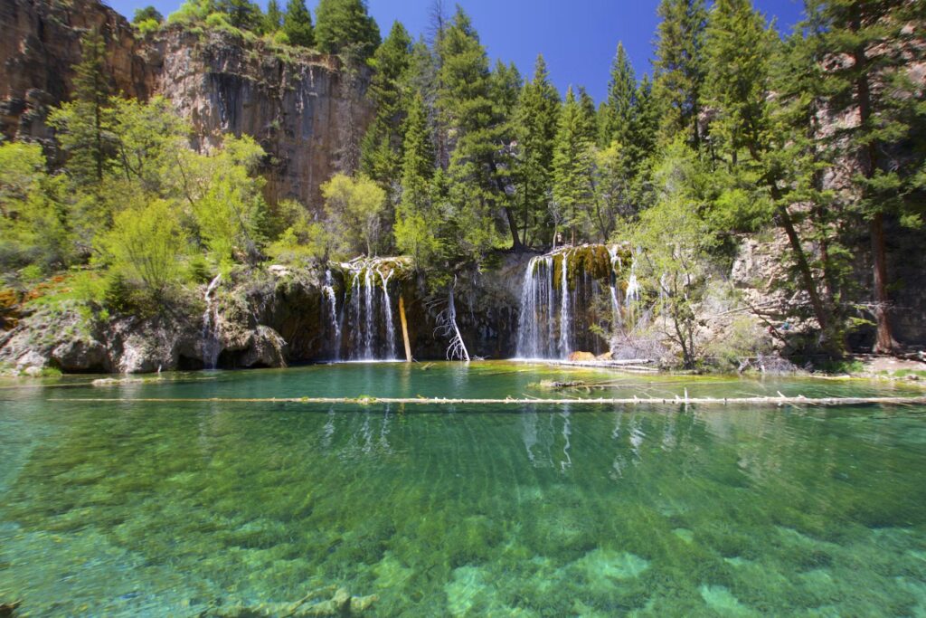 Turquoise waterfalls at Hanging Lake, a favorite among Colorado vacation spots. 