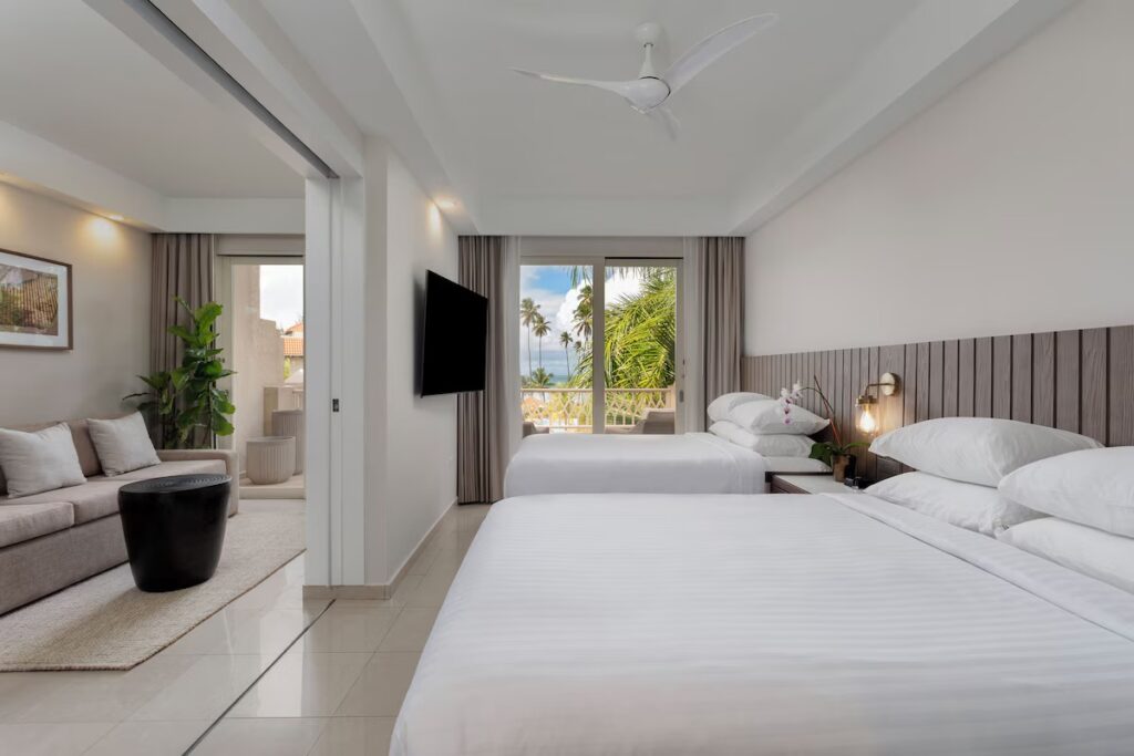 A clean, spacious hotel room with two beds and a balcony at Hyatt Regency Grand Reserve. 