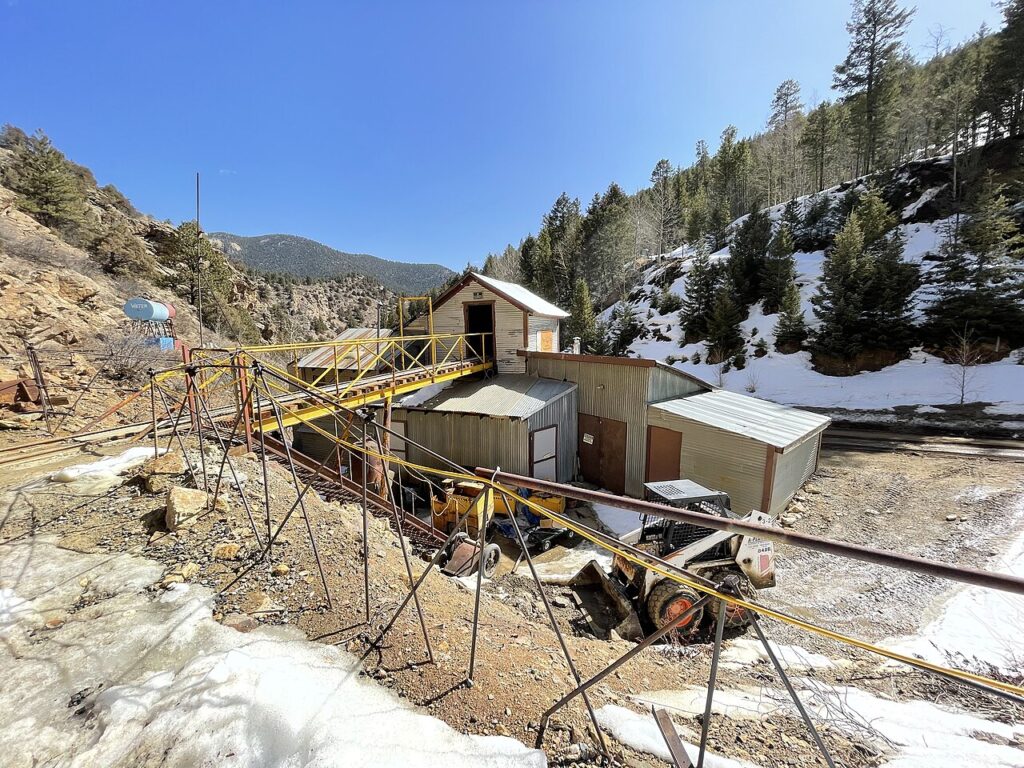 Old mining structures and a yellow conveyor belt at Phoenix Gold Mine. 