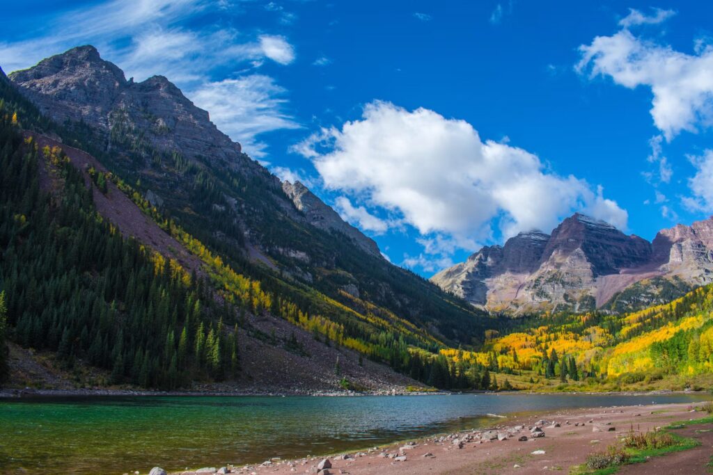 Fall colors surrounding Maroon Lake and the towering Maroon Bells peaks. 