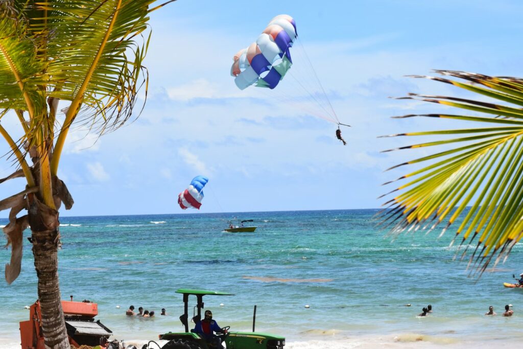 Parasailing over blue waters in Punta Cana, an exciting adventure found on the best caribbean islands for families