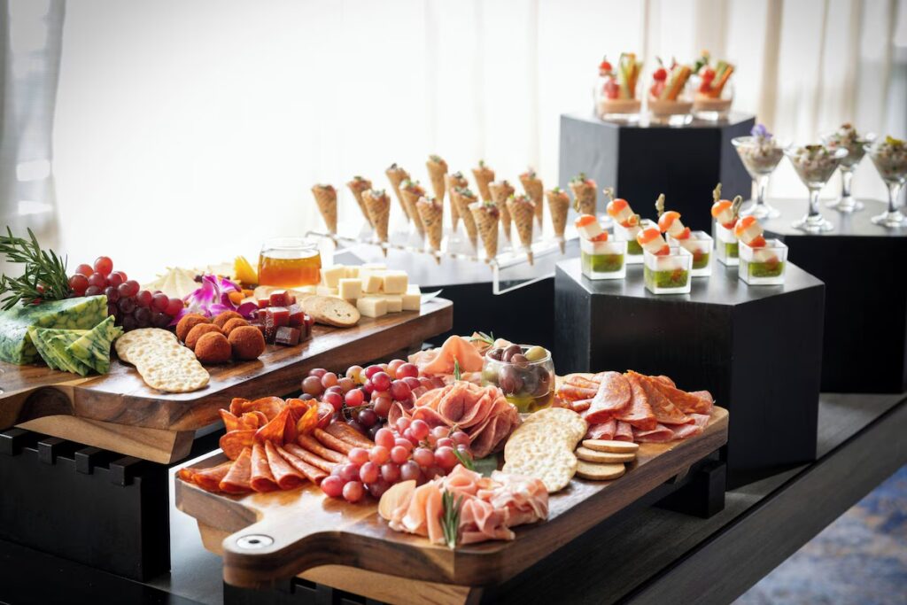 Charcuterie boards and various appetizers elegantly displayed at the Club Lounge 