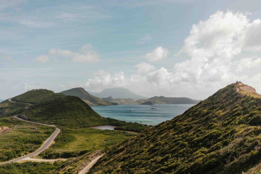 Scenic green hills and ocean bay in St. Kitts, highlighting why it's one of the best caribbean islands for families