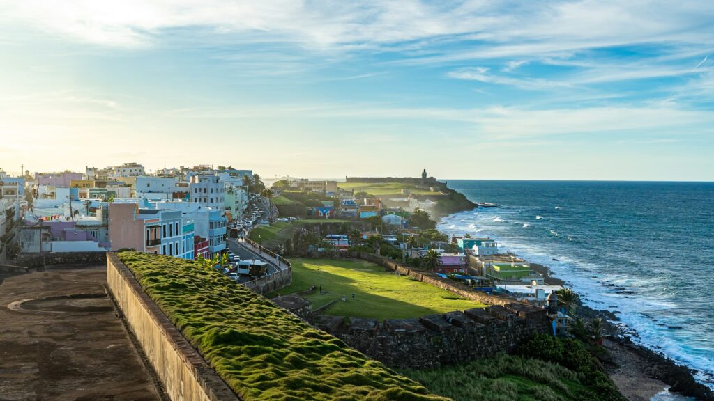 Where to Stay in Puerto Rico: 7 Best Areas & 15 Top Hotels & Resorts (2026) Sunset view of San Juan coastline, perfect for those wondering where to stay in puerto rico.
