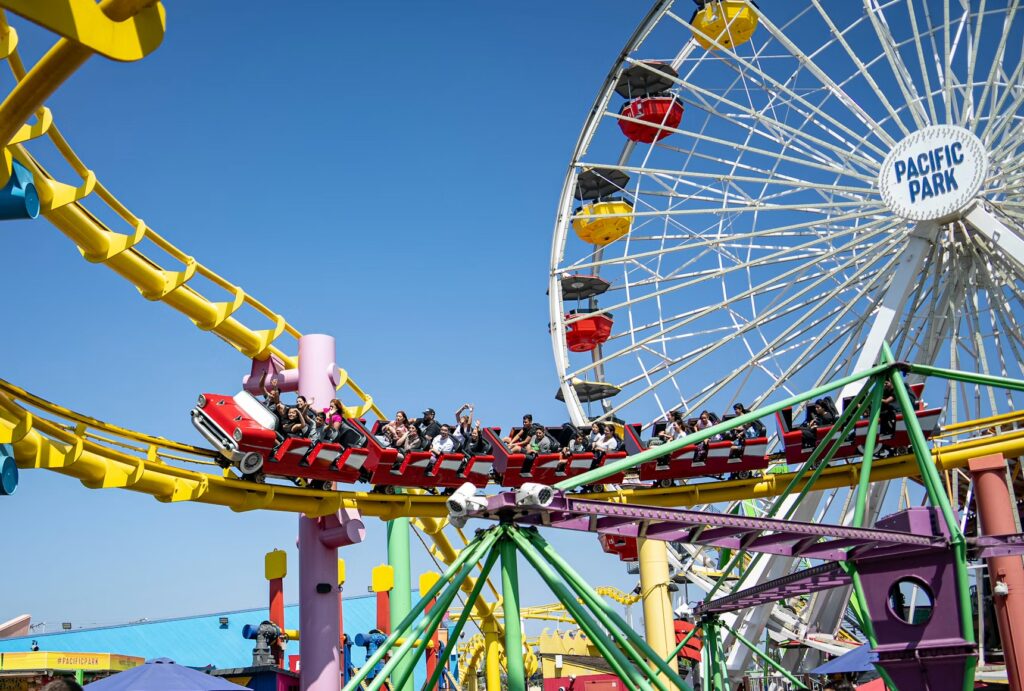 15 Cheap Family Vacations in the US: Trips Under $1,500 (2026) Families enjoying rides at Pacific Park, a cheap family vacation spot in the US