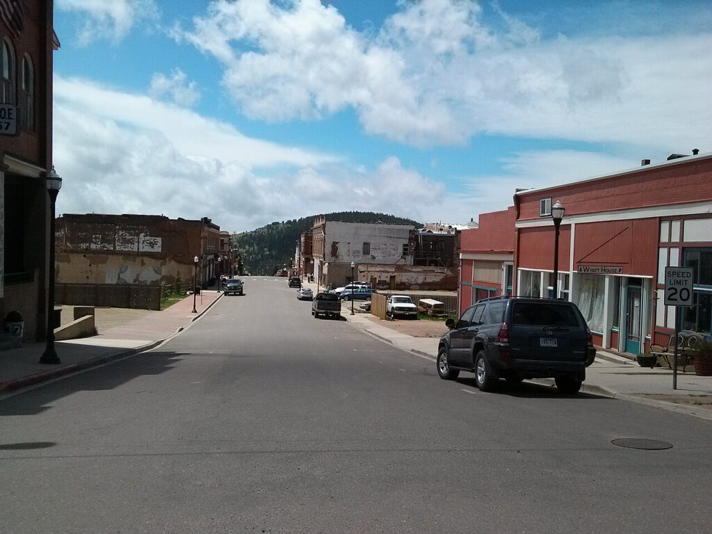 The quiet, slightly weathered historic main street in the old mining town of Victor. 