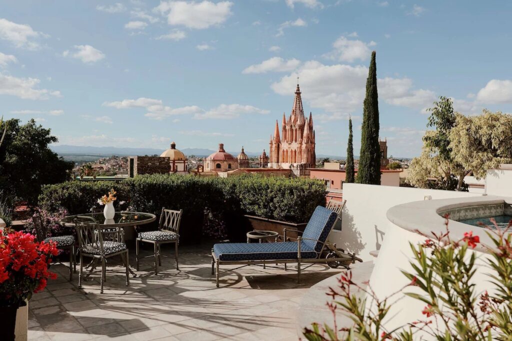 9 Best Hotels in Mexico: Authentic & Boutique Stays (2026) A scenic rooftop terrace at Rosewood San Miguel de Allende overlooking a historic church, showcasing the best hotels in Mexico.