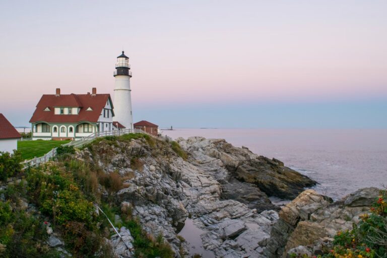 A scenic lighthouse on a rocky shore in Cape Elizabeth, one of the best places to visit in Maine.