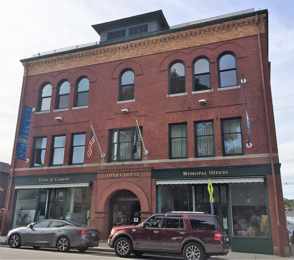 The historic red brick exterior of the Camden Opera House and municipal offices building.