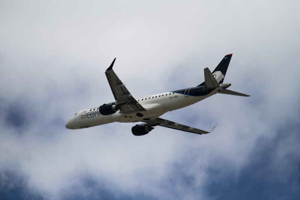 An Aeroméxico commercial airplane flying through the clouds during an international flight to Mexico.