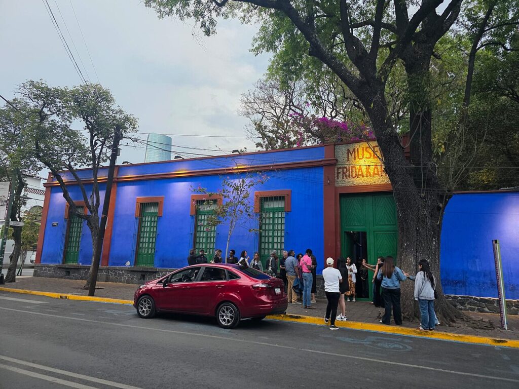 The bright blue exterior walls of the Frida Kahlo Museum, a cultural landmark in the Coyoacán neighborhood of Mexico City.