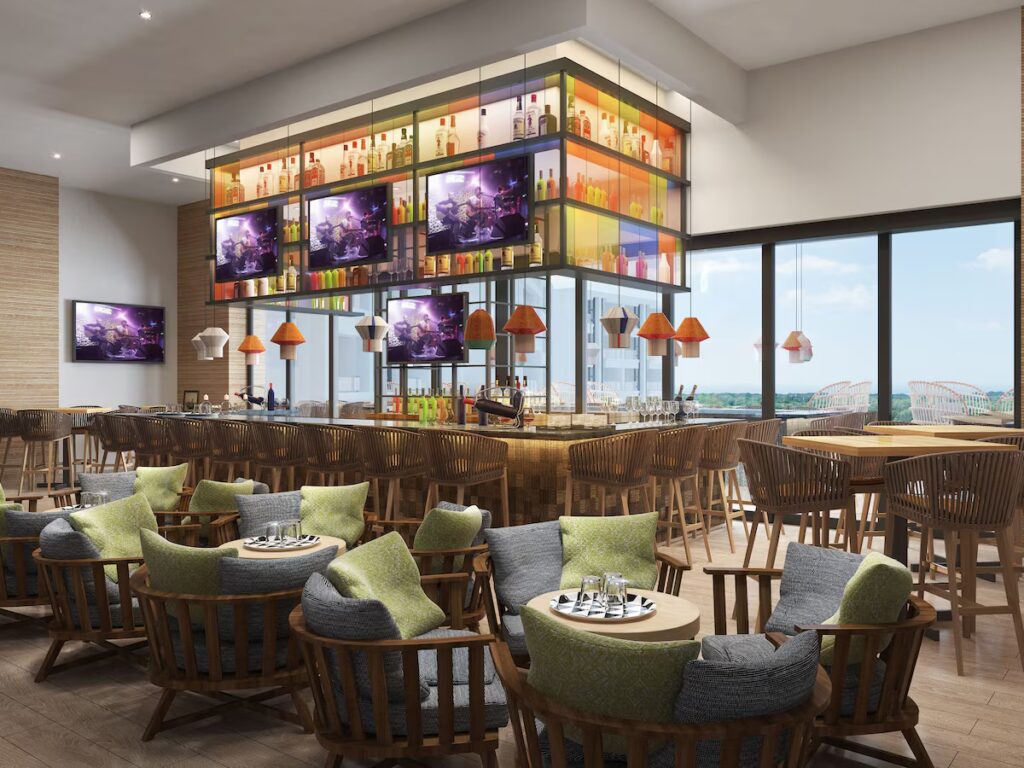 Vibrant sports bar and lounge area with suspended televisions at Hard Rock Hotel Los Cabos. 
