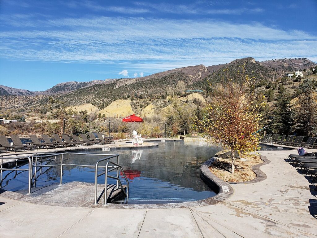 People relaxing in the steaming outdoor pools at Iron Mountain Hot Springs. 