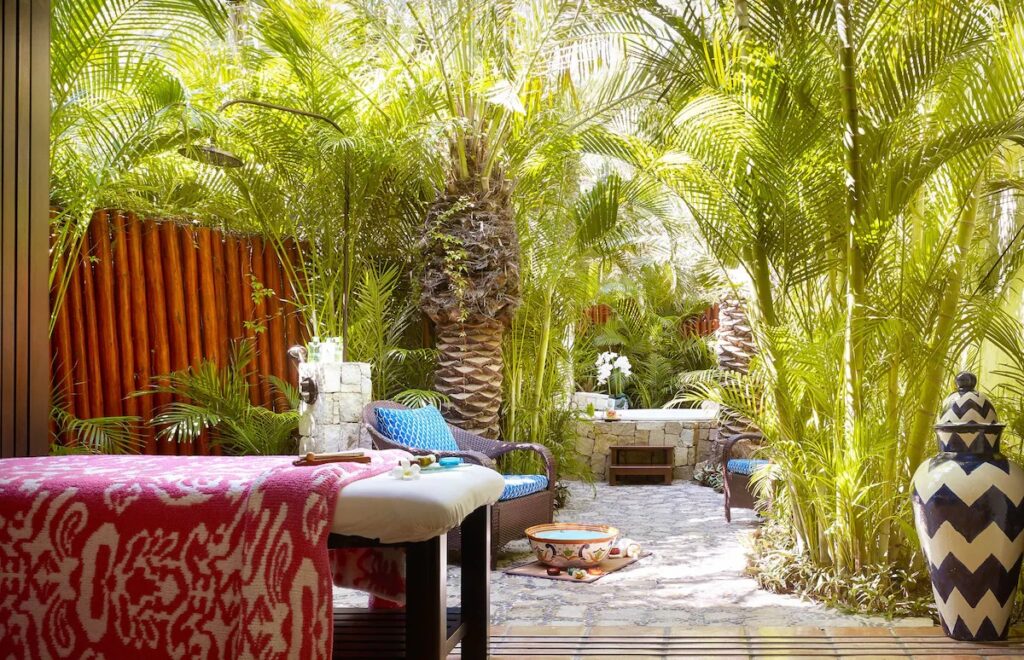 A tranquil outdoor spa setup surrounded by dense, lush palm trees for ultimate privacy at Las Ventanas al Paraíso.