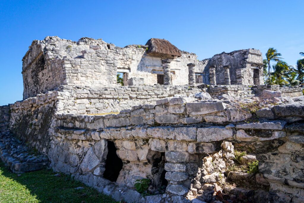 A close-up view of the stone architecture and columns at the cliffside Maya ruins in Tulum.