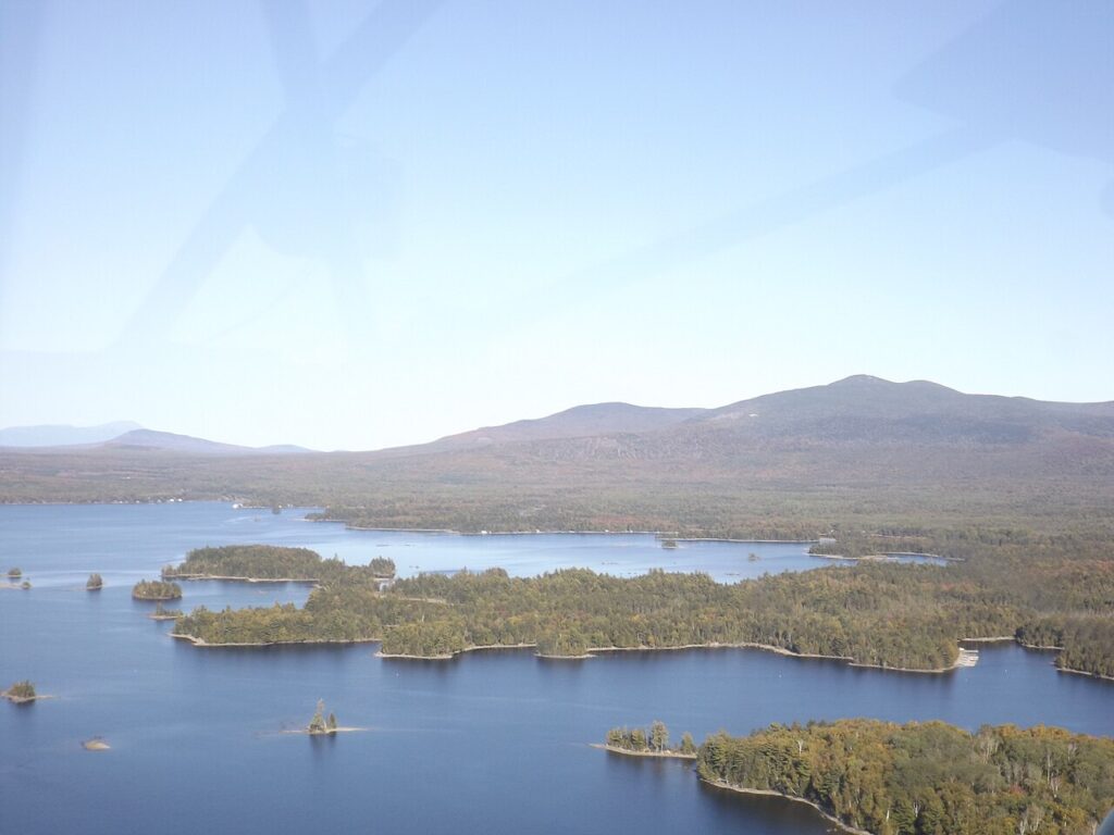 Aerial view of an island-filled lake surrounded by endless forests at Moosehead Lake, Maine.