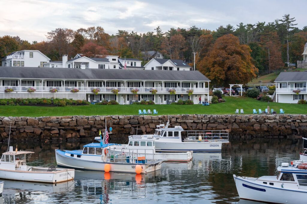 Fishing boats docked in the harbor near the historic wooden drawbridge in Perkins Cove, Ogunquit, Maine.