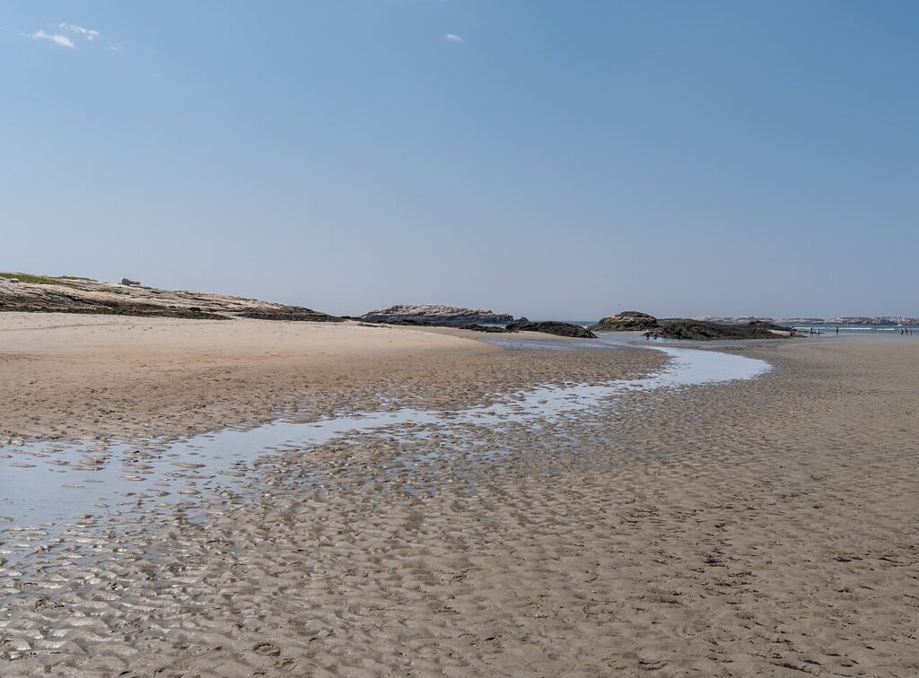 A wide expanse of sand and shallow tidal pools at Popham Beach State Park in Phippsburg. 