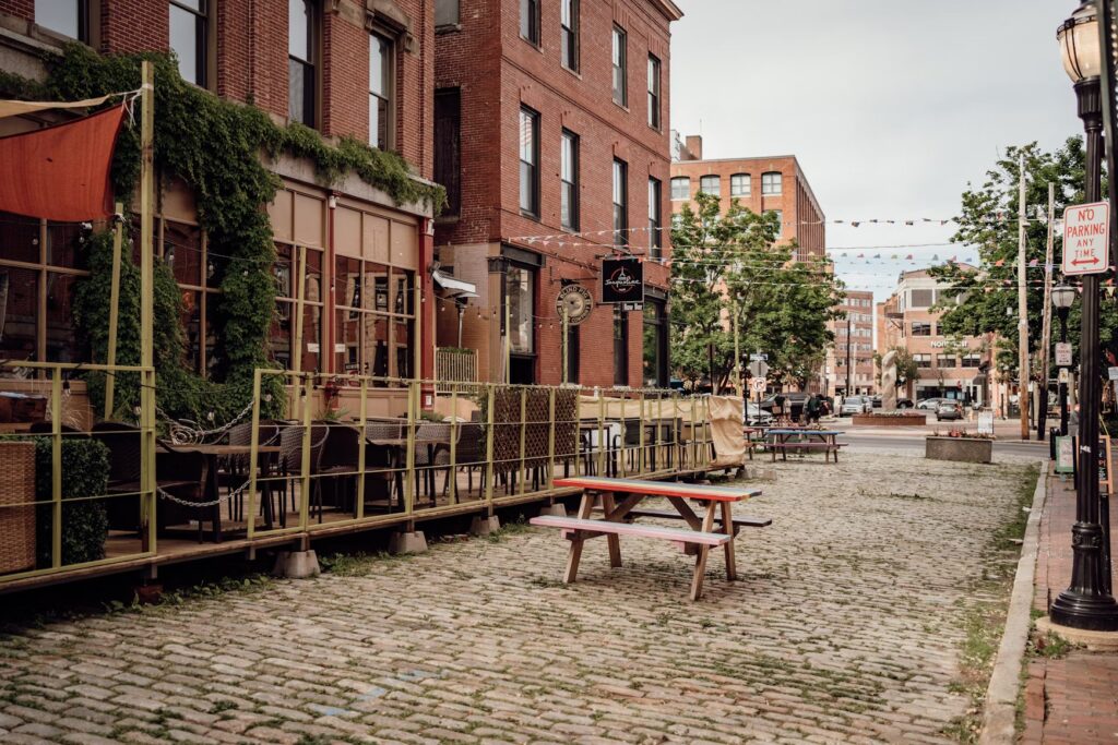 Outdoor dining area on a historic cobblestone street in the Old Port district of Portland. 