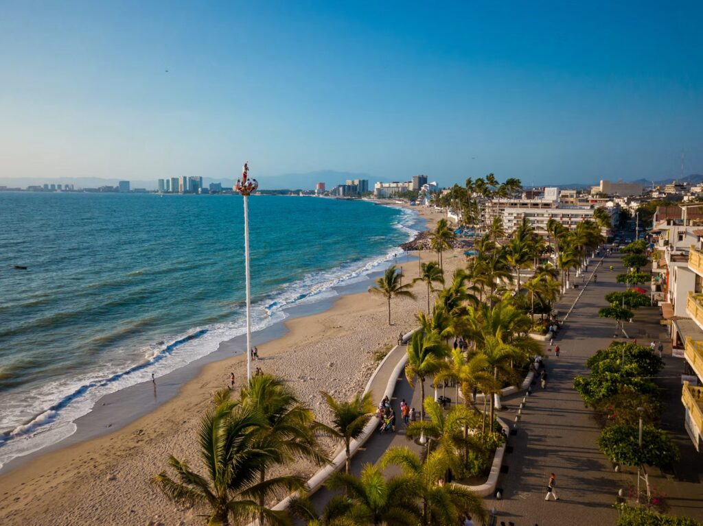 The vibrant, palm-lined Malecón boardwalk stretching along the beach in Puerto Vallarta.