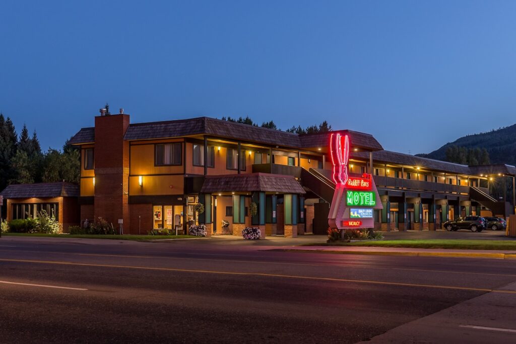 Neon rabbit sign glowing brightly at the Rabbit Ears Motel in Steamboat Springs. 