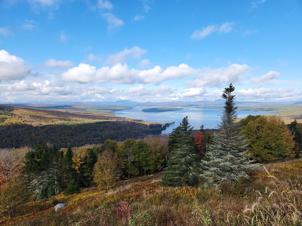 Panoramic view of rolling hills and lakes from the Height of Land overlook in Rangeley, Maine.