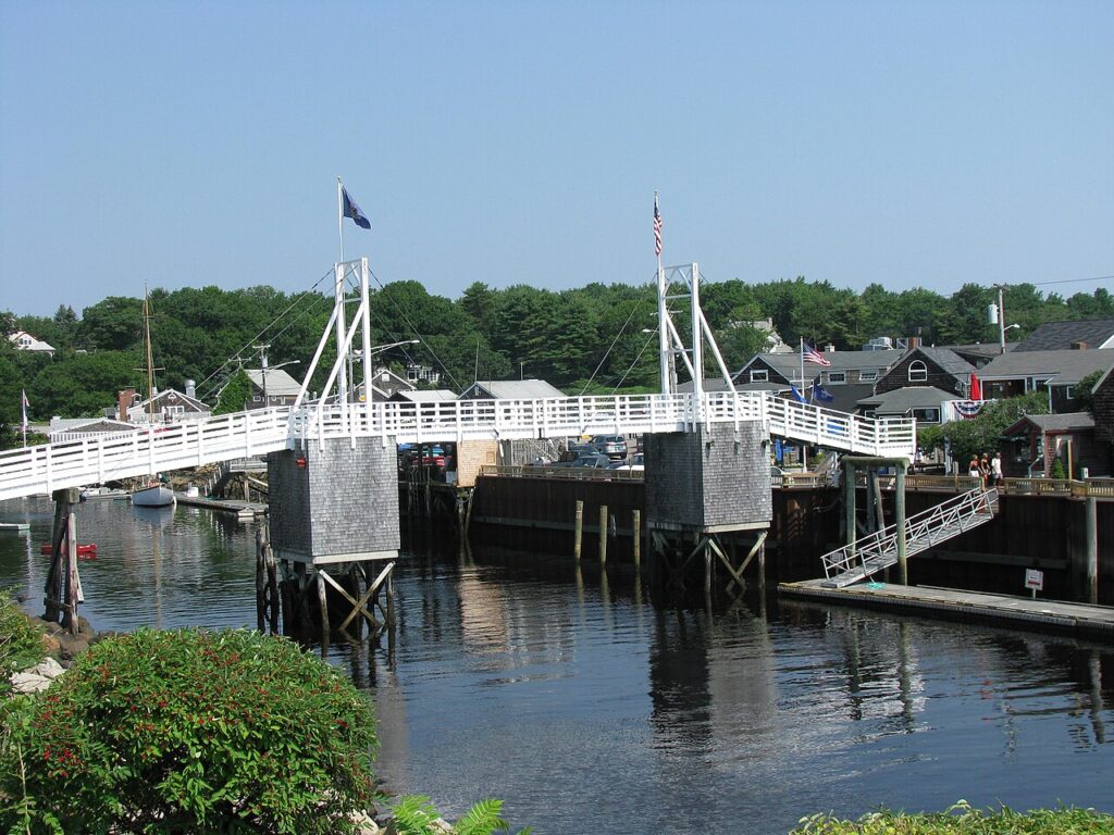 The famous wooden double-leaf draw footbridge spanning across the water in Perkins Cove, Ogunquit, Maine.