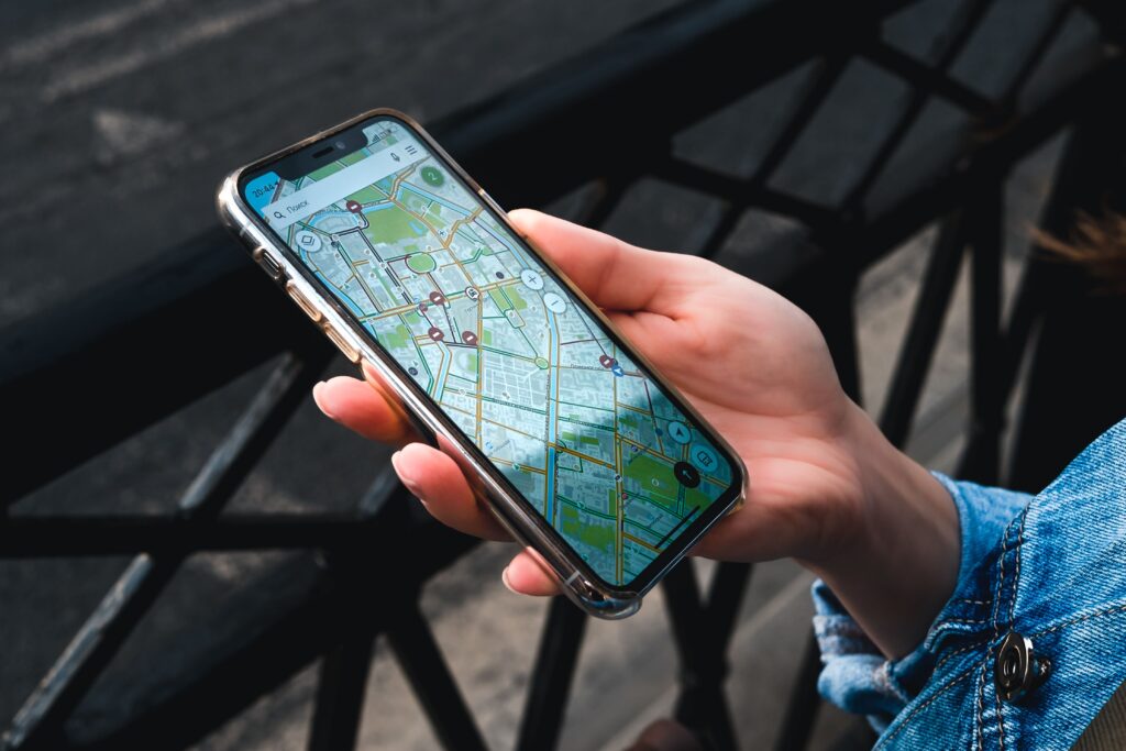 A person holding a smartphone displaying an offline map in a city.