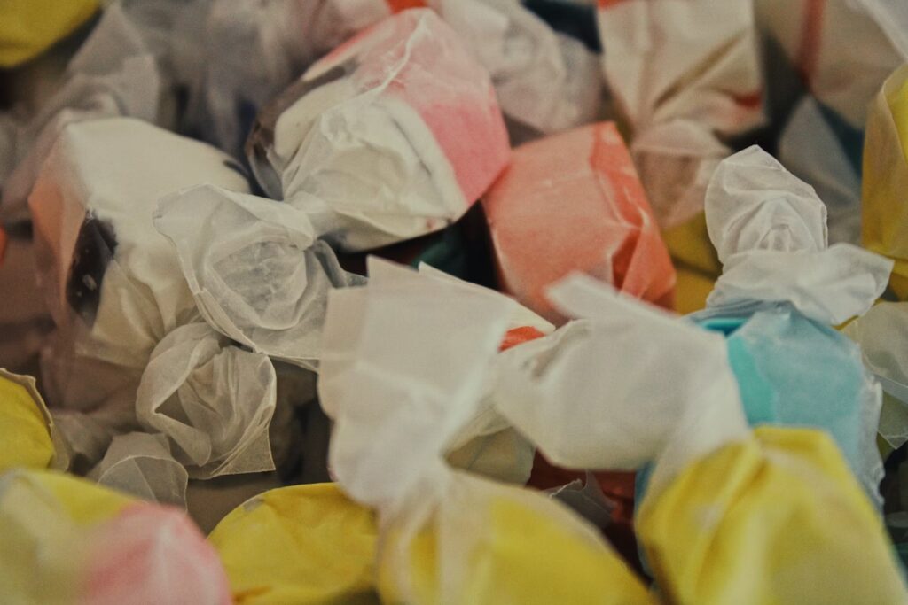 A close-up of colorful, paper-wrapped Goldenrod Kisses saltwater taffy made at The Goldenrod in York Beach, Maine.