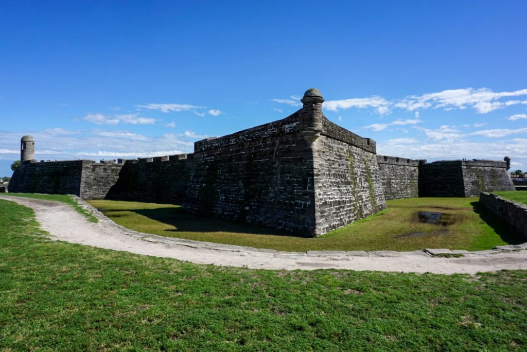 The towering coquina stone walls and corner watchtowers of Castillo de San Marcos National Monument.