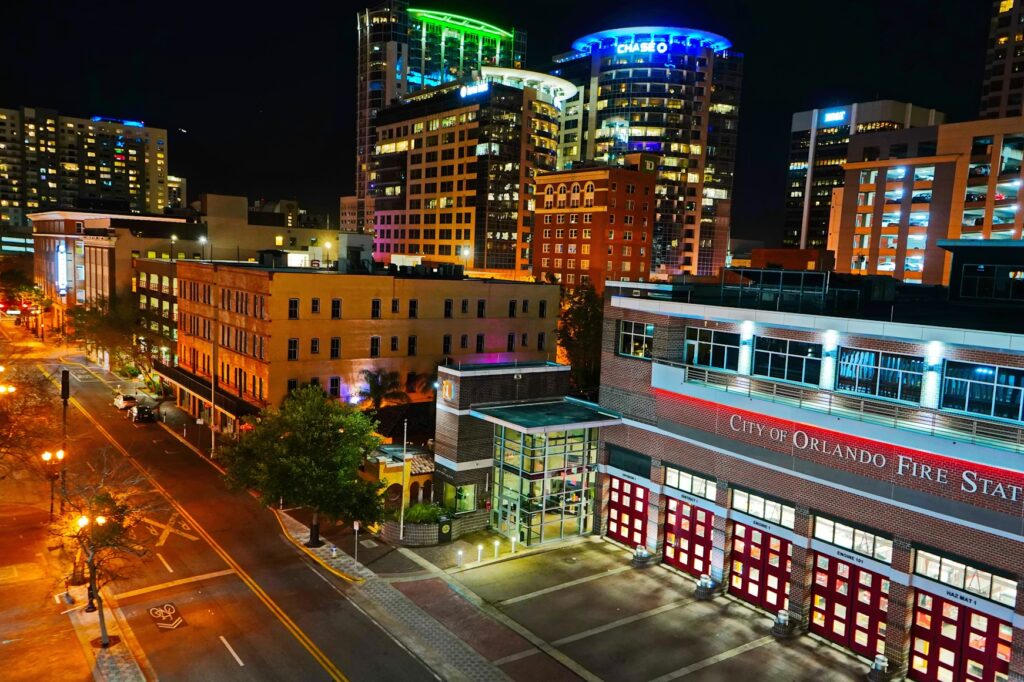 A night view of the illuminated Orlando city streets and buildings.